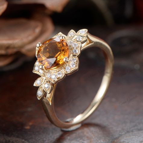 Similar item： https://www.etsy.com/listing/1763948733 This Unique Vintage Edwardian Citrine Ring is an exquisite piece of jewelry that beautifully combines historical elegance with modern sophistication. Crafted from 14K solid gold, the ring features a round-cut champagne citrine as its center stone, exuding a warm and captivating glow. The design includes intricate flower-de-luce motifs, characteristic of the Edwardian era, adding a touch of antique charm. As a solitaire ring, the focus remains Citrine Marquise Engagement Ring, Engagement Rings Topaz Yellow, Yellow Rings Stones, Citrine Engagement Rings, Yellow Topaz Jewelry, Yellow Stone Engagement Ring, Citrine Wedding Ring, Citrine Rings, Citrine Engagement Ring