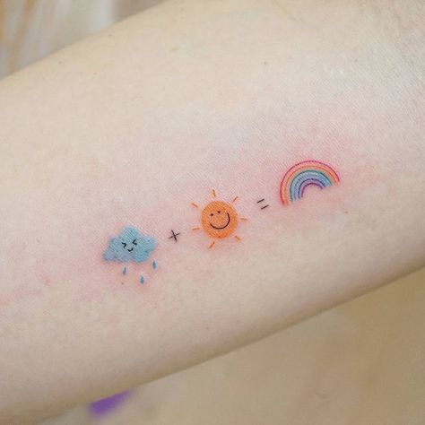 Rain + sun = rainbow tattoo on the inner forearm. Cute Rain Cloud Tattoo, Color Tiny Tattoo, Rainbow Aesthetic Tattoo, Cute Rain Tattoos, Sun Tattoo In Color, Rainbow Colored Tattoo, Rainbow Rain Tattoo, Rain And Rainbow Tattoo, Tattoo Ideas Rainbow