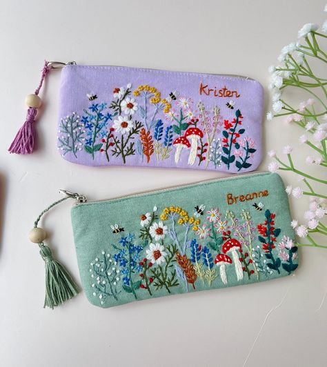 IF YOU NEED A PERSONALIZED DESIGN OR CUSTOM SIZE, PLEASE MESSAGE US. 📍 The pouch is embroidered with beautiful flowers, roses and can be customed your names, completely hand-embroidered from Vietnamese craftsmen.  - Material: soft linen combined with embroidery floss - Texture: embroidered flowers, mushroom and custom text.  - Size: 3.5x7.5" (9x19cm), 4.7x7.5" (12x19cm) The bag is not only pencil case but can be served as an everyday bag for your sunglasses, jewerly, coin purse. 📍  You buy thi Linen Gifts, Embroidery Floss Crafts, Embroidery Pouch, Hand Embroidered Gifts, Handmade Makeup Bag, Embroidery Purse, Linen Pouch, Denim Crafts Diy, Handmade Makeup