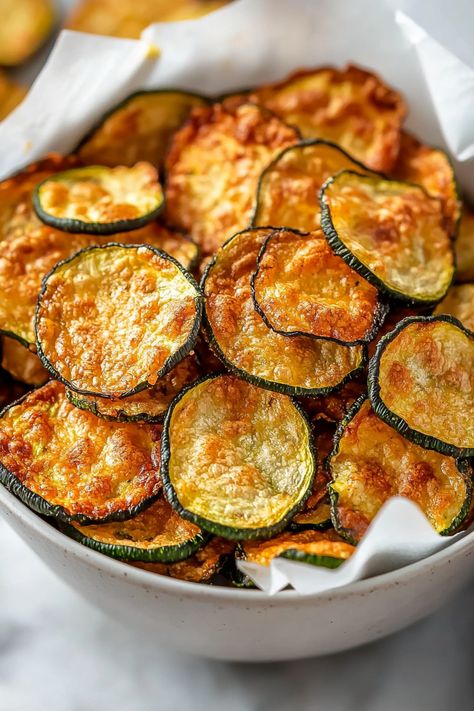 These crispy, delicious air fryer zucchini chips require just two ingredients and are ideal for a quick snack! They're incredibly simple to make and are keto-friendly, gluten-free, and low-carb. Zucchini is one of my favorite vegetables because of its versatility and ease of use in the kitchen. You can use it in a variety of Breaded Zucchini Recipes, Healthy Zucchini Recipes Air Fryer, Zucchini Recipes Air Fryer Easy, Zucchini Chips Baked Air Fryer, Air Fried Zucchini Sticks, Fried Zucchini Air Fryer, Zucchini Chips Airfryer, Zucchini Fritters Air Fryer, Zucchini Air Fryer Recipes