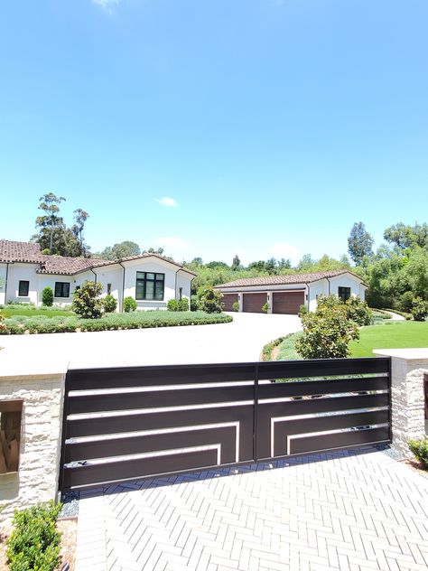 Check Out These Beautiful Garage Doors and a Driveway Gate, installed by Access in 2020!  We design and install every kind of garage door in steel, aluminum, wood, or fiberglass, you name it.  Access would like to thank our customers for giving us an opportunity to make their homes look beautiful. We offer the best designs, quality, service, and automation. We look forward to earning your business.  The Doors You Open Determine the Life You Live Modern Gated Driveway Entrance, Modern Gates Driveway, Gated Driveway, Beautiful Garage, Entrance Landscaping, Aluminum Driveway Gates, Los Angeles Landscape, Automatic Gates Driveways, Driveway Entrance Landscaping