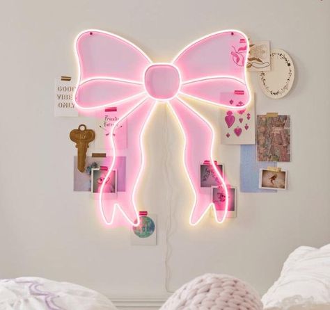 This eye-catching piece features your choice of pink or white LED bulbs forming a glowing bow silhouette, adding a magical touch to any room.  It's constructed from durable iron, plastic, and LED lights, ensuring longevity.  Easy to install with included mounting hardware and powered by a simple plug-in connection at 5 volts, it's both energy-efficient and enchanting. Room Decor Bedroom Pink And White, Girly Room Decor Ideas Bedrooms, Cute Room Ideas Preppy, Cute Led Signs, Preppy Lights, Cute Things To Buy For Your Room, Cute Led Lights, Aesthetic Led Lights, Preppy Bedroom Ideas