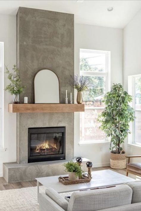 Looking for warmth without the clutter? Our blog post highlights chic electric fireplaces that fit perfectly into small spaces. They're not just practical—they're a style statement. Click to discover which model has the cozy factor you're after. Your snug retreat is just a read away. #GoTinySpace #ElectricFireplaces #CozyHome #InteriorDesign Living Room With Concrete Fireplace, Cement And Wood Fireplace, Earthy Fireplace Decor, Neutral Fireplace Ideas, Concrete Fireplace With Wood Mantle, Sheetrock Fireplace, Concrete Look Fireplace, Interior Fireplace Ideas, Fireplace No Chimney