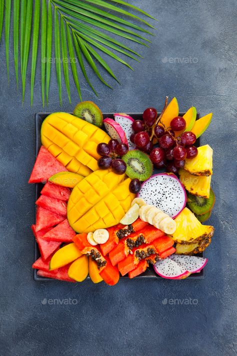 Tropical fruits assortment on a plate. Grey background. Top view. by annapustynnikova. Tropical fruits assortment on a plate. Grey background. Top view. #Sponsored #assortment, #plate, #Tropical, #fruits Fruit Presentation, Fruit Creations, Fruit Platter Designs, Tropical Food, Papaya Fruits, Fruit Decorations, Fruit Box, Fruit Dishes, Fruit Carving