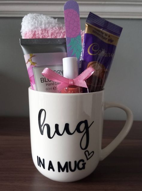 Hug in a mug.Perfect gift to cheer someone up or show someone you care.Each mug contains 1 pair of ladies fluffy socks,1 nail varnish and nail file,1 handcream,choice of hot choc or coffee sachet or vegan option herbal tea. A hug wish bracelet can also be added. Giftwrapped with gift tag. If you would like a personalised message added to tag please leave details.  Mug is hand rinse only not suitable for dishwasher .Free uk delivery. Tea Gift Sets Diy, Mug Hamper Ideas, Cup Filled Gift Ideas, Cricut Travel Mug Ideas, Gift Cup Ideas Filled, Coffee Cup Gift Ideas Filled, Thank You Gifts For Friends, Cheer Up Basket, Mug Gifts Ideas Filled