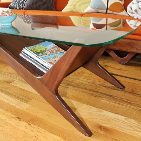 Mid-century modern wood coffee table with retro angles and glass top Cozy Mid Century Modern Living Room Coffee Tables, Mid Century Modern Coffee Table Decor, Mcm Glass Coffee Table, Mid Century Modern Living Room Coffee Tables, 60s Coffee Table, Midcentury Modern Coffee Table, Wood And Glass Coffee Table, Retro Coffee Table, All Glass Coffee Table