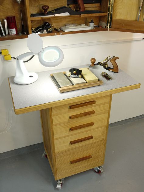 I built this cabinet for use as a sharpening station. It sits directly below my tool cabinet and has plenty of storage for sharpening gadgets.  It's constructed of pine and 1/2" birch plywood. The drawers are inset style and dovetailed. The wide top is covered with plastic laminate.  Casters are 3" double locking from Woodcraft. Finished with Tried & True Varnish Oil.  Completed August 2006. Sharpening Station, Tool Cart, Workshop Ideas, Tool Cabinet, Small Workshop, Tool Shop, Wood Tools, Woodworking Bench, Woodworking Ideas