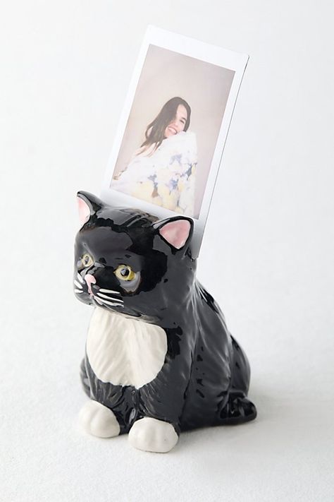 The purr-fect finishing touch to your photo displays, our Grumpy Kitty Photo Stand adds vintage charm to your INSTAX mini memories. This stoneware photo stand features an itty bitty grumpy kitty silhouette. Available exclusively at Urban Outfitters. Features Ceramic photo stand from Urban Outfitters Petite cat silhouette we love Versatile - use it to add a playful finishing touch to your shelves or accent tables UO exclusive Content + Care Stoneware Wipe clean Imported Size Dimensions: 2.25" l x 1.5" w x 2.75" h Weight: 0.13 lbs | UO Grumpy Kitty Photo Stand in Black at Urban Outfitters Aesthetic Cat Decor, Urban Outfitters Gifts, Clay Cat Jewelry Holder, Kitty Silhouette, Clay Cat Incense Holder, Cute Cat Ceramic, Grumpy Kitty, Cat Room Decor, Vintage Trinkets