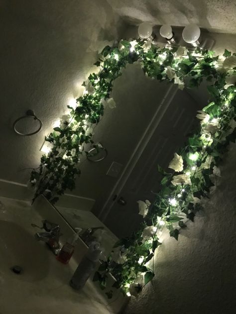 Vine Around Mirror, Fairy Lights On Mirror, Mirror With Fairy Lights Around It, Vines Over Mirror, Flower Framed Mirror, Fake Vines In Bathroom, Vines In Office, Fake Vines Decor Bathroom, Leaves Around Mirror