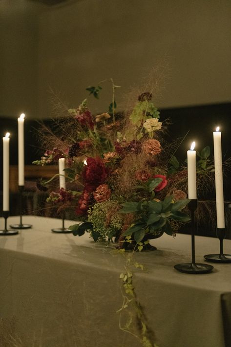 Moody Floral Arrangements Wedding, Burgundy Tablescape, Moody Wedding Florals, Moody Fall Wedding Flowers, Burgundy Winter Wedding, Moody Wedding Draping, Tall Moody Wedding Centerpieces, Winter Wedding Flowers Centerpieces, Moody Wedding Candles