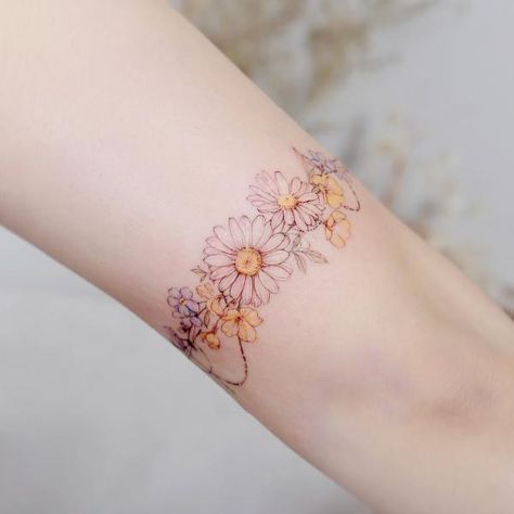 120 Daisy Tattoo Designs with Meanings | Art and Design Daisy Bracelet Tattoos For Women, Daisy And Dandelion Tattoo, Sunflower Arm Band Tattoo, Daisy Bracelet Tattoo, Flower Ankle Bracelet Tattoo, Braclet Tattoo Women, Flower Arm Band Tattoo, Virgo Flower Tattoo, Fine Line Daisy Tattoo