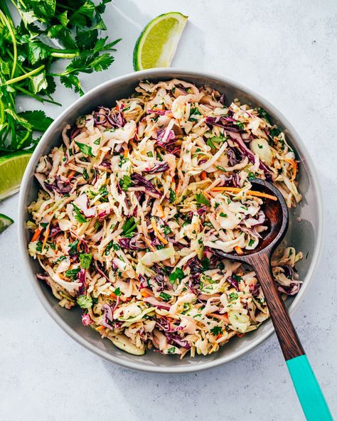 This cilantro lime slaw is fresh and zingy, with just the right pop from the citrus! It's great as a side dish or taco filling. #cilantrolimeslaw #coleslaw #coleslawrecipe #slawrecipe #cilantrolimecoleslaw #sidedish #easyside #healthyside #picnic #pitchin Creamy Lime Coleslaw, Cilantro Lime Taco Slaw, Lime Slaw For Fish Tacos, Cilantro Lime Coleslaw Mexican Slaw, Citrus Slaw Fish Tacos, Best Coleslaw Recipe, Cilantro Lime Slaw, Winter Salad Recipes, Salad Dressing Recipes Healthy