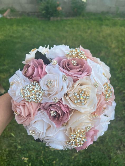 Handmade Quinceañera Bouquet/ Wedding.  With Ivory, Blush and Mauve Roses. Finished off with Gold brooches.  *Please note brooches can change in style due to availability.* Decor / color combinations can be changed upon request. {This is a made to order Bouquet} Bear Roses, Rose Gold Bouquet, Mauve Roses, Wedding Vow Renewal Ceremony, Quinceanera Bouquet, Homecoming Flowers, Ribbon Flowers Bouquet, Blush Bouquet, Wedding Brooch Bouquets