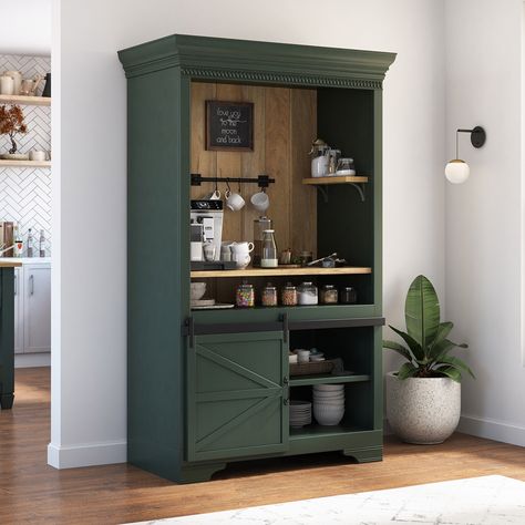 For a cozy and aesthetic touch to your interiors, bring our ergonomically designed Sherbrooke Solid Wood Barn Door Farmhouse Coffee Bar Hutch. With its charming design and ample storage space, it's a must-have for any coffee lover. Entirely handcrafted from solid wood, this beautiful coffee bar hutch boasts a 2-tone outlook that blends the charm of the rustic texture of solid wood with a hand-applied dark finish, resulting in a visually stunning design. In addition to its attractive look, the pi Bookshelf Turned Coffee Bar, Armoire To Coffee Bar, Green Coffee Bar Ideas, Forest Green Coffee Bar, Coffe Closet, Farmhouse Bar Cabinet, Wardrobe Coffee Bar, Coffee Bar Colors, Dark Green Coffee Bar