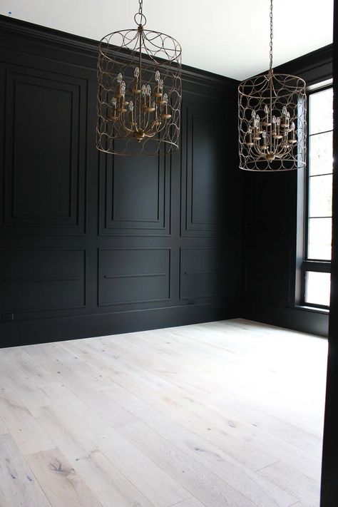 Are you looking for the perfect shade of black paint for an accent wall, kitchen island or even just your front door? Whether you want to go bold with all over color or just as a touch of contrast, Sherwin Williams Tricorn Black is one of the best shades of black paint. Read this full paint review to see if it's the right color for your home! White Floor Black Walls, Black Panelling Dining Room, Light Oak Floors Dark Walls, Black Wall Design Living Room, Wall Niche Behind Tv, Close Off Dining Room French Doors, Black Crown Molding Bedroom, Manly Bathroom Wallpaper, Tricorn Black Wainscoting