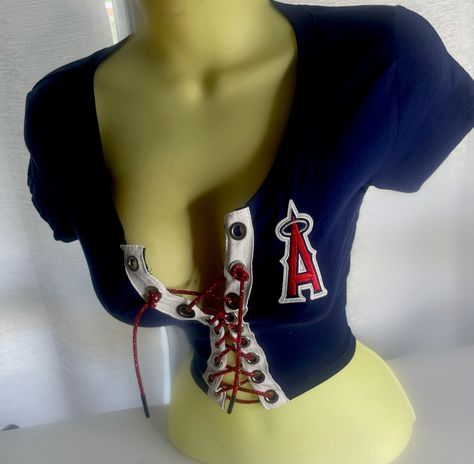 LA Angels Crop Top with red lace. Please note estimated time to ship these items is 7-10 business days as they are made to order. If you need it right away please send us a message and we will try our best to accommodate your request.  Don't see your team? Send us a message with a request and we will gladly accommodate it. What To Wear With A Pink Top, Shirts That Show Off Chest, Underboob Shirts Outfits, 2000s Crop Tops, 2000s Club Fashion, No Sew Top, Cute Red Tops, Bedazzled Clothes, Tight Outfits