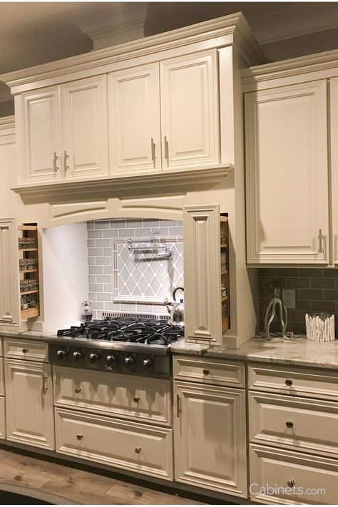 This traditional kitchen’s hearth hood and spice pullouts offer both convenience and style. Kitchen Island Storage Ideas, Ivory Kitchen Cabinets, Vanilla Kitchen, Granite Kitchen Countertops, Ivory Kitchen, Traditional Kitchen Cabinets, Beige Backsplash, Kitchen Cabinets Ideas, Colonial Kitchen