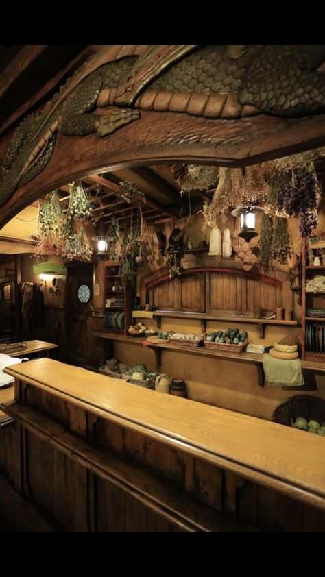 Fantasy Store Interior, Green Dragon Tavern, Lotr Decor Interiors, Hobbit Hole Interior, Hobbit Kitchen, Lotr Decor, Tavern Kitchen, Fantasy Bar, Fantasy Lighting