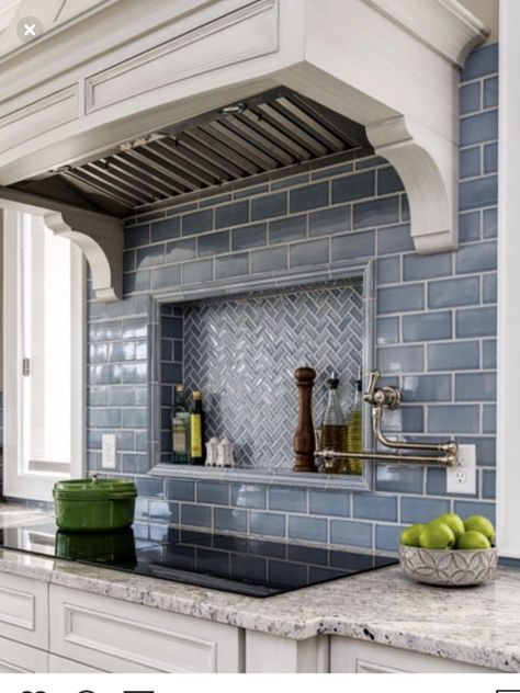 a kitchen with white cabinets and blue tile backsplashes on the counter top
