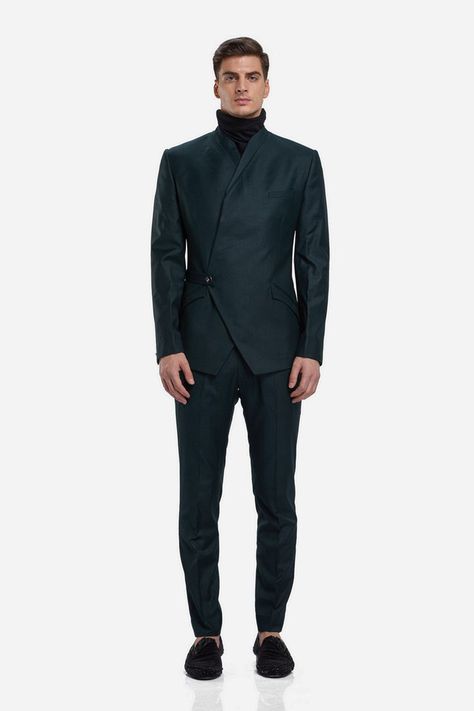 Of Sheer Decadence And Elegance; this multi-angular asymmetrical wrapped bandhgala is punctuated with an angular constructed panel crafted in navy blue suiting. And finished with a half belt closure. The creation is paired with matching straight trousers. Keep styling minimal, think a white turtle neck t-shirt or Orion shirt barely peeking through the bandhgala. Finish with a pair of leather oxfords and sleek pushed back hair #GauravGupta #GauravGuptaMan #GGMan #Bandhgala Asymmetrical Suit Men, Pushed Back Hair, India Fashion Men, Prince Suit, Tshirt Details, White Turtle Neck, Gaurav Gupta, Turtle Neck Men, Mens Sherwani