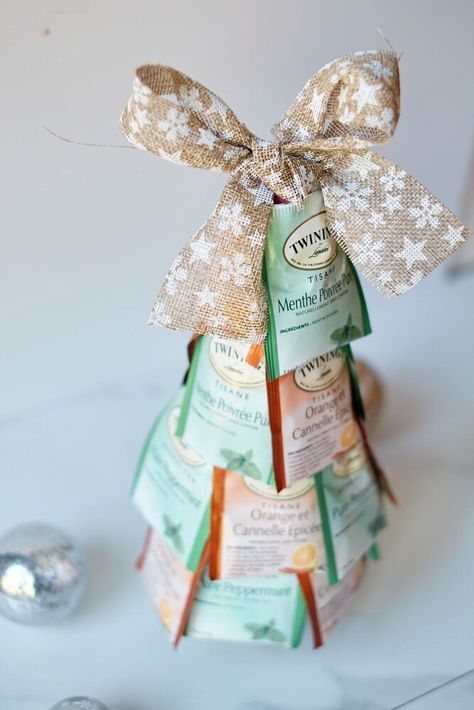 If you're looking for a cheap but thoughtful Christmas gift, you can't go wrong with this tea bag Christmas tree!﻿When you just don't have enough money to give gifts, but you want to anyway, this Christmas tea tree is an excellent thrifty gift idea. Supplies 1 Styrofoam cone (7 inches)2 packages of tea bags (approx. 10-12 of each)Bow (optional)Toilet paper tube (optional) Sort Your Tea Remove tea bags from the boxes. Sort by colors if you have different types. Attach Bags Layer the… Free Printable Christmas Cards, Alternative Christmas, Cone Christmas Trees, Alternative Christmas Tree, Enough Money, Christmas Gifts For Coworkers, Thoughtful Christmas Gifts, Free Christmas Printables, Printable Christmas Cards