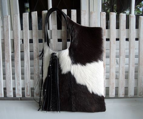 "BLACK WHITE TOTE with Woven Leather Tassels Calf Hair Bag with Hand Leather Cross Weave Country South Western Cowgirl Fur Bag Shoulder bag A personal favorite; beautifully soft to the touch. Wears easily over shoulder, stylish and luxurious. We carefully hand pick all cow hides ourselves; pre planning each piece and the best markings, so that every piece is unique & no two are ever alike.  The Megan Shoulder bag is perfect for your days out, extending beautifully into the evenings. The unique c Hair Bag, Western Bag, Cowhide Purse, Cowgirl Fashion, Large Silk Scarf, White Tote Bag, Black Cow, Fur Bag, White Tote