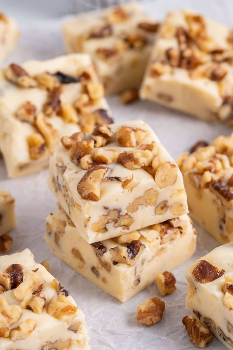 Maple Walnut Fudge stacked on top of parchment paper. Maple Nut Fudge Recipe, Maple Walnut Fudge Recipe, Fudge With Marshmallow Cream, Maple Walnut Fudge, Maple Fudge Recipes, Walnut Fudge Recipe, Walnut Cookie Recipes, Chocolate Walnut Fudge, Maple Fudge