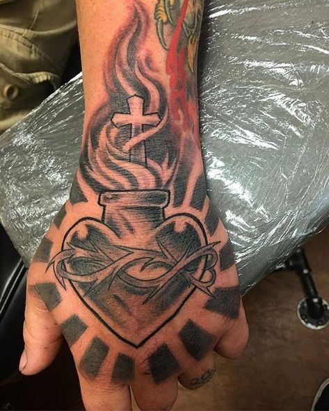 Love Tattoos For Men Heart, Sacred Heart Hand Tattoo, Heart Tattoo Neck, Heart Tattoo For Men, Tattoos For Guys Wrist, Hand Tats For Guys, Heart Tattoo Men, Heart Neck Tattoo, Heart Hand Tattoo