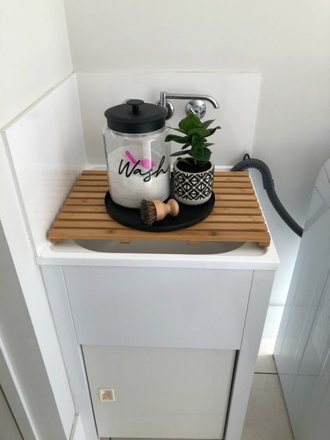 Use a bamboo board from Kmart to create an instant bench over the laundry tub. Laundry Decor Kmart, House Decor Kmart, Kitchen Bench Organisation, Bathroom Bench Decor, Kmart Kitchens, Kitchen Bench Styling, Kitchen Bench Decor, Kmart Organisation, Laundry Bench