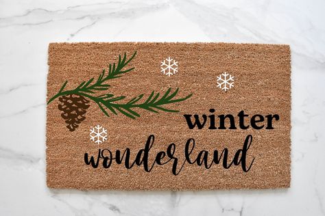 WINTER WONDERLAND DOORMAT Let it snow! Our winter wonderland welcome mat is the perfect way to create a warm and cute Christmas entryway. Front door mats make perfect wedding, housewarming, and birthday gifts!MATERIAL: natural coir front with a durable vinyl backingSIZES: 18" x 30" and 1/2 inch thick CARE: shake or vacuum to clean and refreshDESIGN: hand-painted with durable outdoor all-weather paint This hand-painted doormat is the perfect decorative accent to any entryway! Made with 100% coir, Winter Entryway, Christmas Entryway, Front Door Mats, Door Mats, Welcome Mat, Cute Christmas, Pine Tree, Winter Wonderland, Perfect Wedding