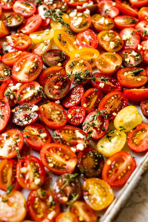 A Slow Roasted Cherry Tomatoes recipe, perfect for your summer garden harvest! Sweet & juicy cherry tomatoes slowly roast in the oven with olive oil, garlic, & fresh herbs, resulting in intensely sweet-tart tomatoes with the most wonderful hearty texture. Roasted tomatoes are perfect for tossing in pasta, salads, sandwiches, on pizzas, adding to a cheese board, or simply snacking by the handful – a summer staple! #roastedtomatoes #ovenroastedtomatoes #sundriedtomatorecipes #tomatorecipes Slow Roasted Cherry Tomatoes Oven, Sundried Cherry Tomato Recipes, Sundried Cherry Tomatoes Oven, Slow Roasted Cherry Tomatoes, Slow Roasted Vegetables, Slow Roasted Tomatoes Oven, Roast Cherry Tomatoes In Oven, Oven Roasted Cherry Tomatoes Recipe, Oven Dried Cherry Tomatoes