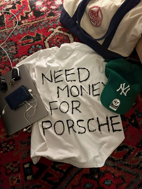 need money for porsche white t-shirt forest green baseball cap ny yankees blue Louis Vuitton wallet trader joes bag apple MacBook earbuds rug aesthetic Porsche Shirt, Need Money For Porsche, Porsche Girl, Classy Cars, 2024 Vision Board, Vroom Vroom, 2024 Vision, Dream Car, Fashion Killa