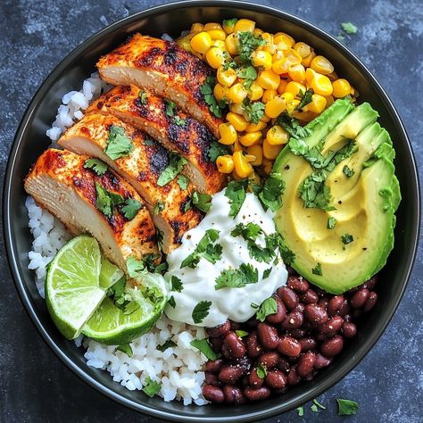 🍚🌽 Savor the flavors of street food with our Street Corn Chicken Rice Bowl! A fiesta in every bite! 🌶️ #StreetFoodStyle #DeliciousEats Street Corn Chicken Rice Bowl Ingredients: Chicken breast (2, grilled and sliced) Rice (2 cups, cooked) Corn kernels (1 cup, roasted) Black beans (1/2 cup) Avocado (1, sliced) Cotija cheese (1/4 cup, crumbled) Lime (1, juiced) Cilantro (for garnish) Sour cream (2 tbsp) Chili powder (to taste) Instructions: Arrange rice in bowls. Top with grilled chicken, r... Cuban Chicken Rice Bowl, Grilled Chicken With Rice Recipes, Healthy Chicken Ideas For Dinner, Cilantro Rice Bowl, Chimichurri Chicken Bowl, Rice And Avocado Bowl, Veggie Chicken Bowl, Meal With Avocado, Healthy Greek Chicken Bowls