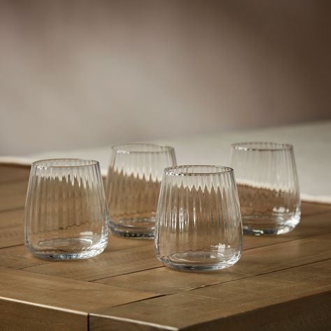 A delicately detailed piece. This set of 4 Coniston glass tumblers are stunningly crafted pieces made of mouthblown glass, with soft, detailed grooves surrounding their edges. These glasses are perfect for holding short drinks, juices and water. The simple and clear shape and style makes these beautiful additions to your current glassware collection. Also available as a singular glass. Glass For Drinks, Kitchen Cups Set, Kitchen Drinking Glasses, Glass Kitchen Utensils, Glass Sets Drinking, Cute Drinking Glasses, Ikea Glassware, Water Glass Aesthetic, Juice Glass Design