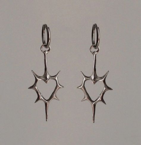 Front view of the heart Stellar Edge Earrings in a gray background Alt Earrings Aesthetic, Silver Jewelry Women, Gothic Earrings Aesthetic, Grunge Piercings Ear, Silver Gothic Jewelry, Silver Charm Earrings, Cool Ear Piercings Punk, Cool Silver Jewelry, Black Earrings Aesthetic