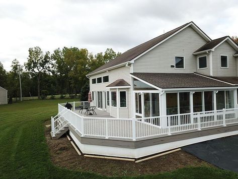 Beautiful wrap around deck built for these homeowners in Walworth, NY along with a sunroom to sit on top. They now get to enjoy their beautiful backyard views from their new, large deck, or their brand new sunroom. Our Project Designer worked with them to bring their visions to life. The Herringbone pattern adds dimension of character & style. Call us for your free estimate, & check out our website for more pictures of projects like this one! (315) 331-6462 Sunroom With Wrap Around Deck, Large Wrap Around Deck, Wrap Around Covered Deck, Wrap Around Back Deck, Raised Homes, Irish Farmhouse, Wrap Around Balcony, Backyard Views, Screened Porch Designs