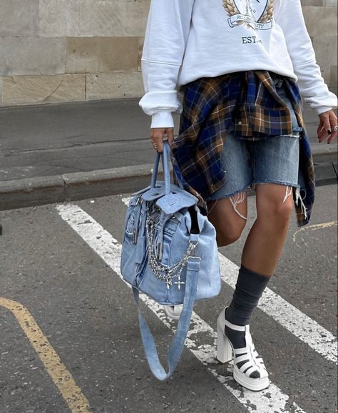 A girl wearing a jeans short, white sweatshirt, a orange and blue shirt, grey socks, white sandals and a jeans Birkin Hermès with jewels Chrome Hearts on it Birkin Outfit, Creative Bag, Gift Inspo, Sweatpants Shorts, Jeans Bag, Jelly Sandals, Street Style Outfit, Vintage Bags, Design Inspo