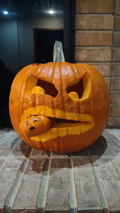 A scary big pumpkin has a little pumpkin in its mouth Big Pumpkin Eating Little Pumpkin, Big Pumpkin Carving, Big Pumpkin Carving Ideas, Big Pumpkin, Biggest Pumpkin, Pumpkin Carving Ideas, Carving Ideas, Pumpkin Carving, Pumpkins