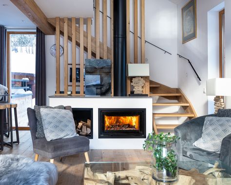 Wood burner in a ski chalet in Chamonix with a wooden staircase Teal Couch Living Room, Wood Stove Installation, Staircase Wood, Wooden Staircase Design, Verbier Switzerland, Wooden Staircase, Wood Stove Fireplace, Chalet Interior, Open Staircase