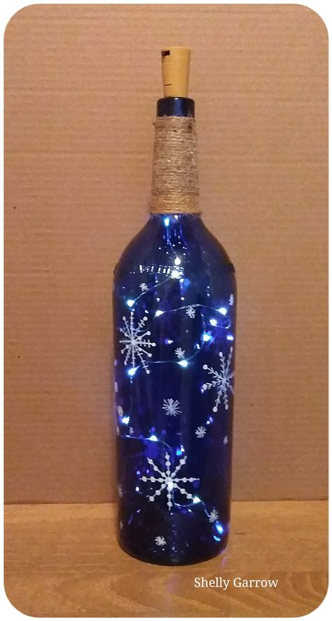 Painted Lighted Wine Bottles, Glass Bottles With Lights Inside, How To Frost Wine Bottles, Painted Bottles With Lights, Painted Bottles Christmas, Crafts Using Wine Bottles, Christmas Painted Bottles, Diy Projects With Wine Bottles, Wine Bottle Painting Ideas