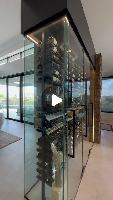 PAUL LUNDGREN on Instagram: "Wine rooms, wine cabinets or wine walls have become a special feature in most of our builds. This one is no exception, it has quickly become a focal point to this home. The entertainers dream.  #desertisland @aft_construction  @cosan.studio  @kristinhazendesign  @hammertonlighting  @theresastirlingartstudios  @caesarstoneus  @summitstoneaz  @distinctivecustomcabinetry  @kohler @solstice.stone  @mountainwestwindowsanddoors" House Wine Cellar Ideas, Wine Built In, Temperature Controlled Wine Room, Double Sided Glass Wine Wall, Wine Bar Home Ideas, Wine Wall Ideas Dining Rooms, Wine Shelves Wall Modern, Modern Wine Cellar Design, Wine Rooms In House