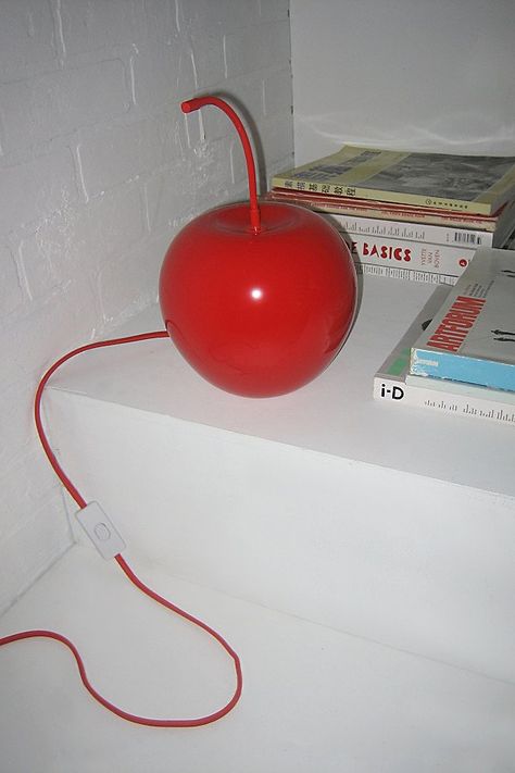 The cherry on top of your bedside displays, this fruit lamp features a juicy cherry silhouette that lends whimsical appeal to your lighting. A fun addition to your unique lighting collection, this fruit lamp casts a warm, red glow throughout your space. Available exclusively at Urban Outfitters. Features Cherry Table Lamp from UO Home Unique lighting in a juicy cherry silhouette Plug in; inline switch Requires one E12 Standard Base 74W bulb - not included Assembly required Compact fluorescent compatible UO exclusive Content + Care Assembly required - assembly instructions are included. Glass, iron, fabric cord Wipe clean Imported Made in compliance with US electrical standards. To use this item outside of the US, pair with an outlet adapter and voltage converter made specifically for use i Unique Decorations, Chrome Home Decor, Hallway Light Fixtures Low Ceilings, Food Home Decor, Cool Stuff For Your Room, Y2k Home Decor, Cozy Lighting Living Room, Kitchen Lamp, Cherry Decor