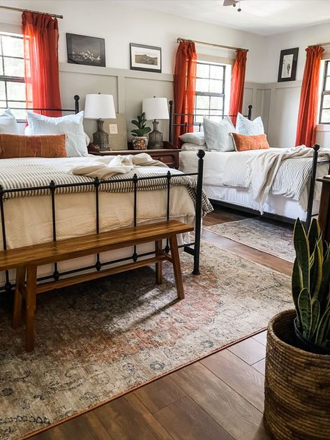 vintage modern guest room with two queen beds, four poster beds, #FoundItOnAmazon, board and batten, bench at the foot of the bed, cactus silk pillows, taupe walls, fawn pillows, lake house, vintage art, art ledge, board and batten with art ledge, bright curtains, burnt orange, LVP floors Two Queen Beds One Room, 2 Queen Beds In Room, Two Queen Beds, Double Queen Bedroom, Guest Bedroom With 2 Beds, Room With 2 Queen Beds, Bedroom With 2 Queen Beds, Room With 2 Full Size Beds, Rooms With 2 Beds