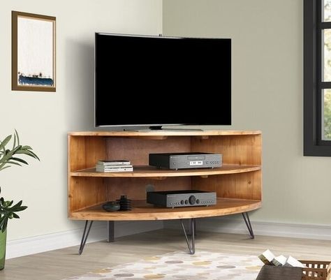 A corner TV console sure to help you put your furniture in the most practical spots, even if you want everything facing the TV in your L–shaped living room. Corner Media Stand, Wood Corner Tv Stand, Corner Tv Stands, Lodge Homes, Corner Tv Stand, Corner Tv, Cool Tv Stands, Media Stand, Mobile Tv