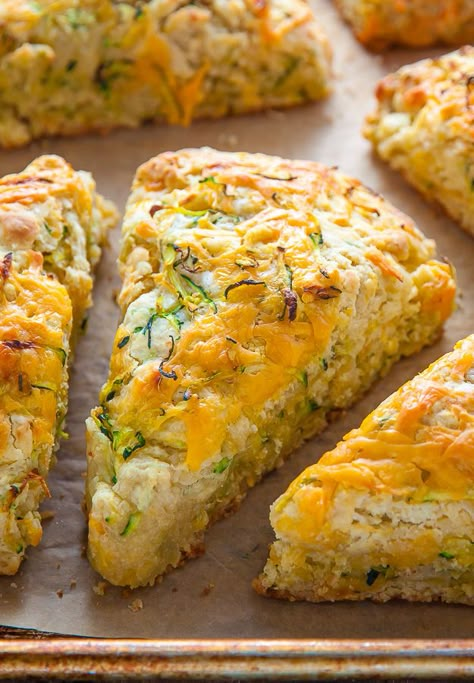 My favorite savory scone recipe loaded with sharp cheddar cheese and fresh zucchini! Who knew veggies could taste this good!? Zucchini And Cheddar Scones, Savory Bakes Recipes, Zucchini Cheddar Bites, Zucchini Cheddar Scones, Zucchini Cheese Biscuits, Zephyr Squash Recipes, Zucchini Recipes Baked Goods, Bakerbynature Recipes, Zucchini Bisquick Recipes