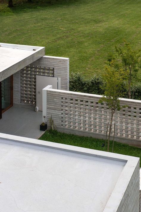 Unique Concrete Walls Act As A Privacy Fence And Allow The Breeze To Pass Through At This Home Breeze Block Entrance, Concrete Fence Wall, Fence Wall Design, Breeze Block Wall, Compound Wall Design, Concrete Block Walls, Entrance Wall, House Fence Design, Concrete Fence