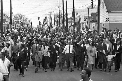 In this March 21, 1965, photo, Dr. Martin Luther King, front row, fifth from right, waves as marchers stream across the Alabama River on the first of a five day, 50-mile march to the state capitol at Montgomery. The march helped secure the approval of the Voting Rights Act Selma March, Selma Alabama, Montgomery Alabama, King Photo, Dr Martin Luther King, Civil Rights Leaders, Civil Rights Movement, The Rev, Iconic Photos