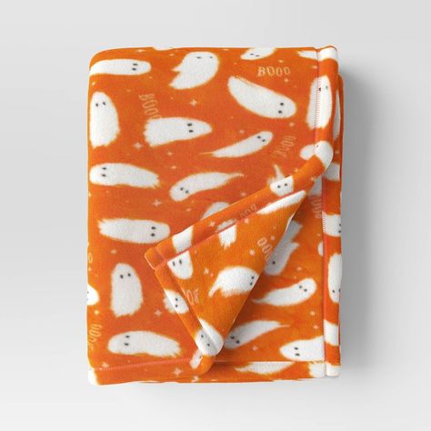 Snuggle up in fun and frightening style with this Ghost Printed Plush Halloween Throw Blanket from Hyde & EEK! Boutique™. This plush throw blanket features a white ghost and 'Booo' text pattern on a bright orange backdrop for a fun Halloween vibe. Made from soft and lightweight knit fabric, this blanket will keep you feeling cozy. Drape it over the back of your sofa or armchair to reach for while lounging, reading or watching TV. Hyde & EEK! Boutique™: Thrilling delights. Curious oddities. Fall Blanket Aesthetic, Cute Fall Room Decor, Cute Halloween Stuff, Colorful Halloween Decor, Spooky Blanket, Fall Blankets, Halloween Throw Blanket, Streamer Party Decorations, Fall Products