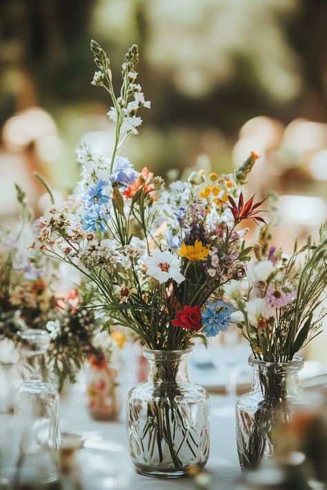 70+ Wildflower Centerpieces to Complete Your Boho Look | Matched Hearts Diy Homecoming Bouquet Simple, Wildflower Bridal Shower Table Decor, Wild Flower Centerpieces Wedding Simple, Soft Wildflower Wedding, Wedding Decorations Wildflowers, Wild Flowers Centerpieces, Wildflower Bud Vases Wedding, Dark Wildflower Bouquet, Wildflower Table Centerpieces