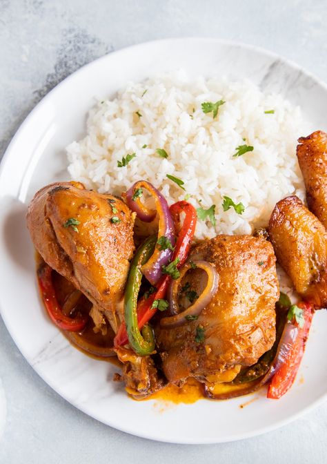 Dominican Braised Chicken or Pollo Guisado served on a plate with white rice, beans and maduros Chicken Guisado, Guisado Recipe, Dominican Cooking, Dominicano Recipes, Stewed Chicken, Meat Dish, Popular Dishes, Dominican Food, Braised Chicken